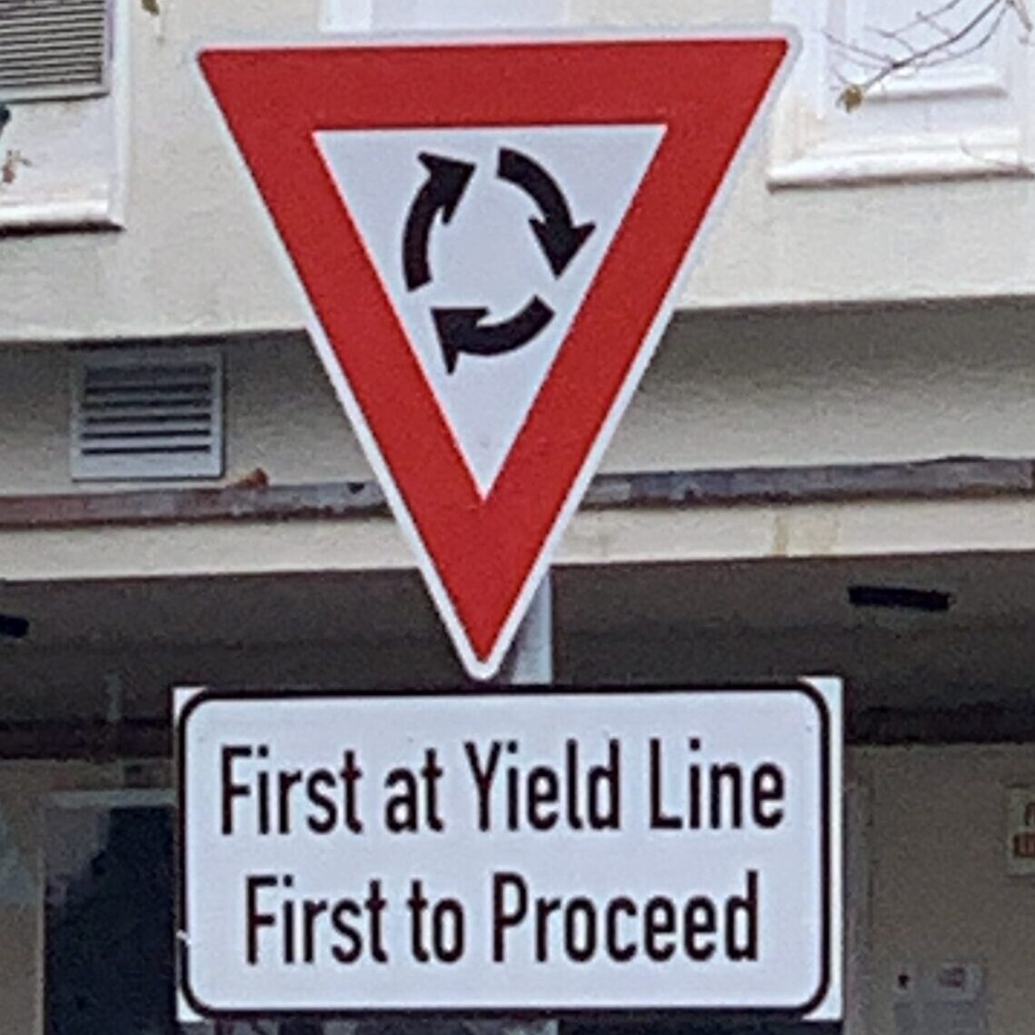 Mini-roundabout sign – First at yield line, first to proceed.